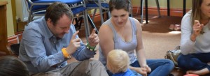 parents and baby doing sign language and music