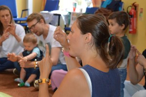 Signs and Sounds leader Rachel Xerri-Brooks signing to children and parents